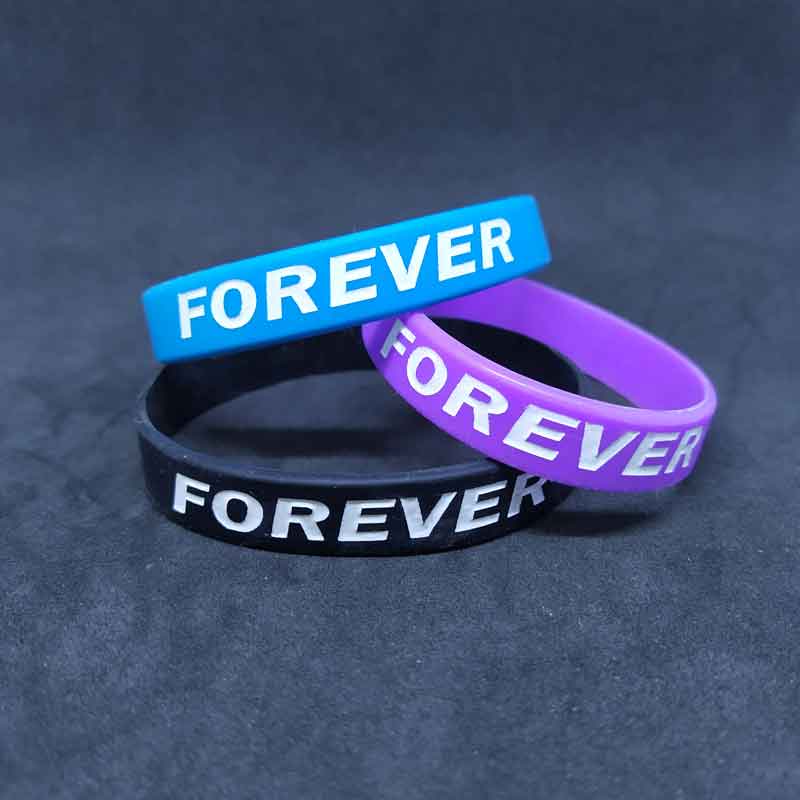 Bracelets with embossed color filled inscription on request